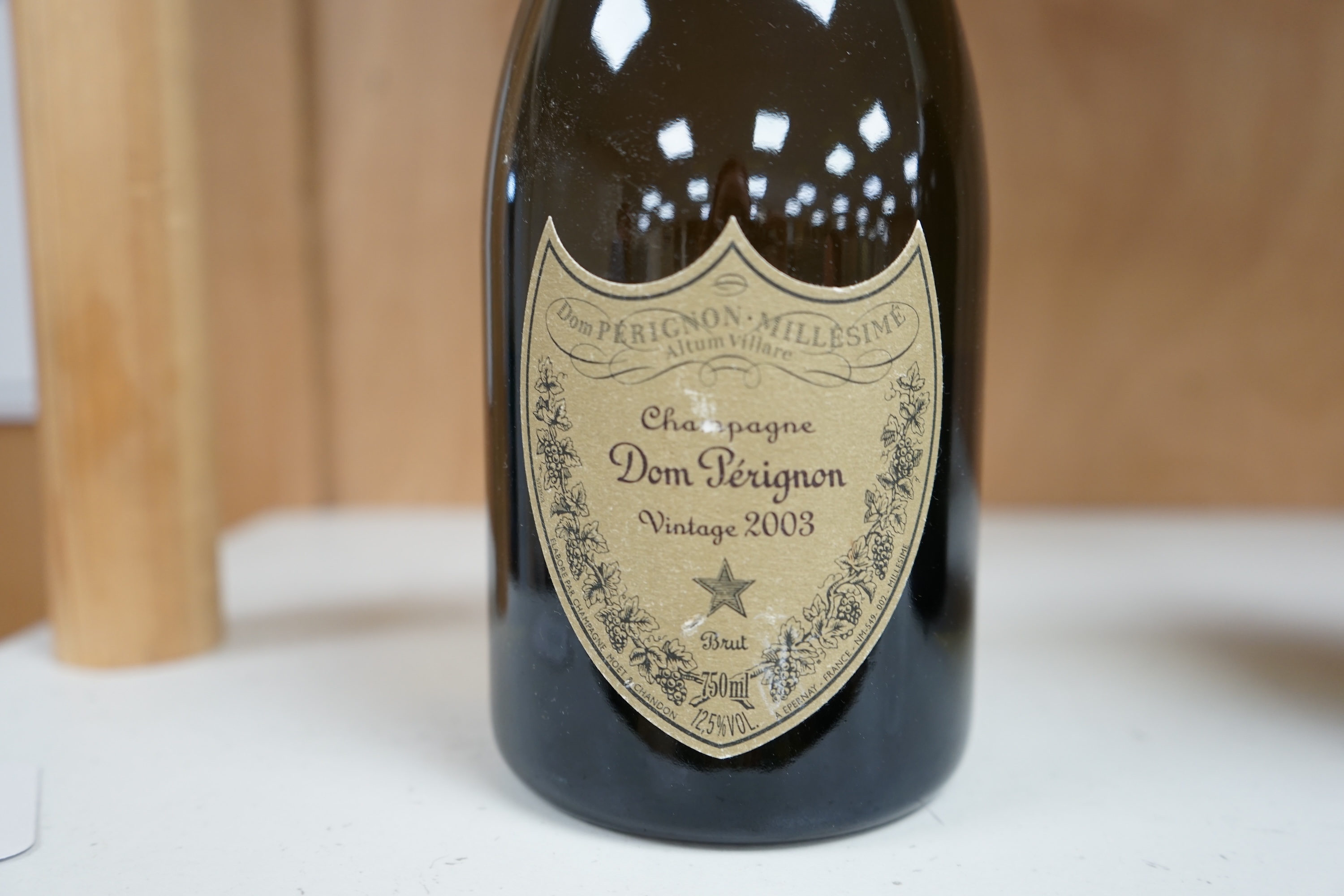 A 2003 vintage bottle of Dom Perignon champagne. Condition - fair to good, minor label wear, etc.